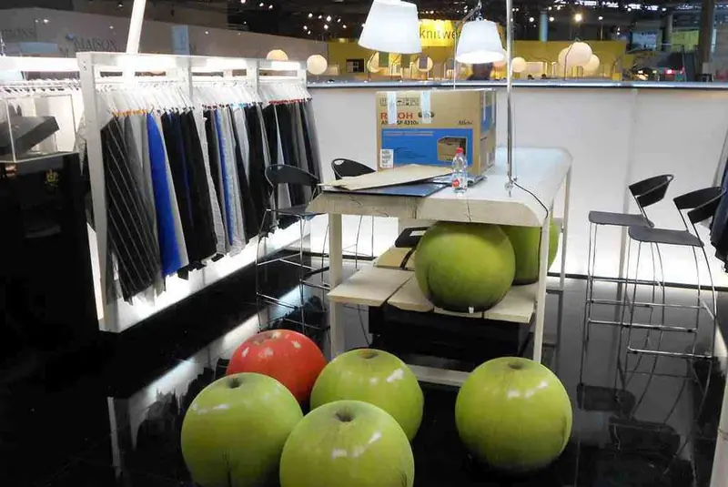 Stand con abiti e mele verdi decorative