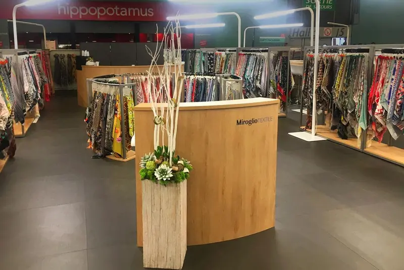 Stand con banco in legno e abiti appesi